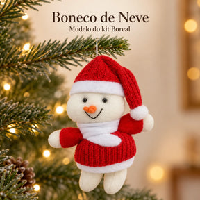 Um boneco de neve do kit Boreal, com gorro vermelho e cachecol branco, acompanhado do nome do modelo.